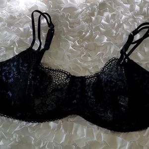 Black and shimmery blue Adore Me bra and panties set.